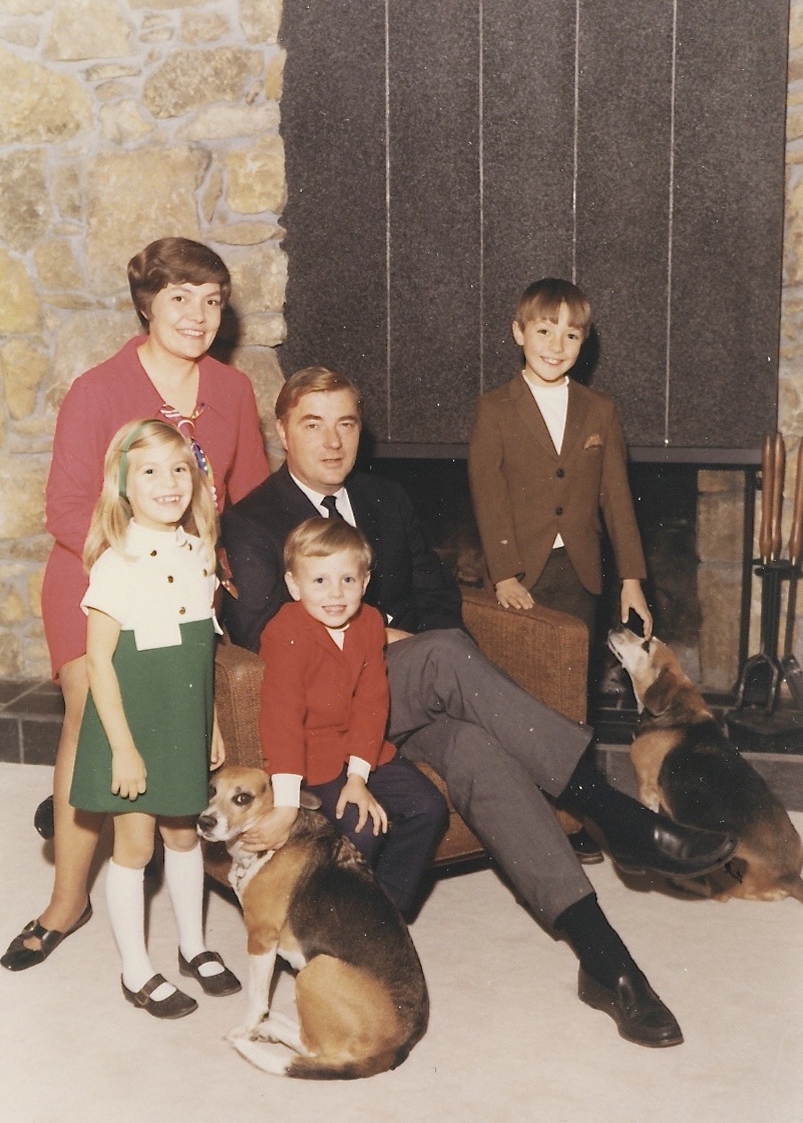 Laura, Mom and Dad, John, and me (with beagles and my bangs), circa 1968.