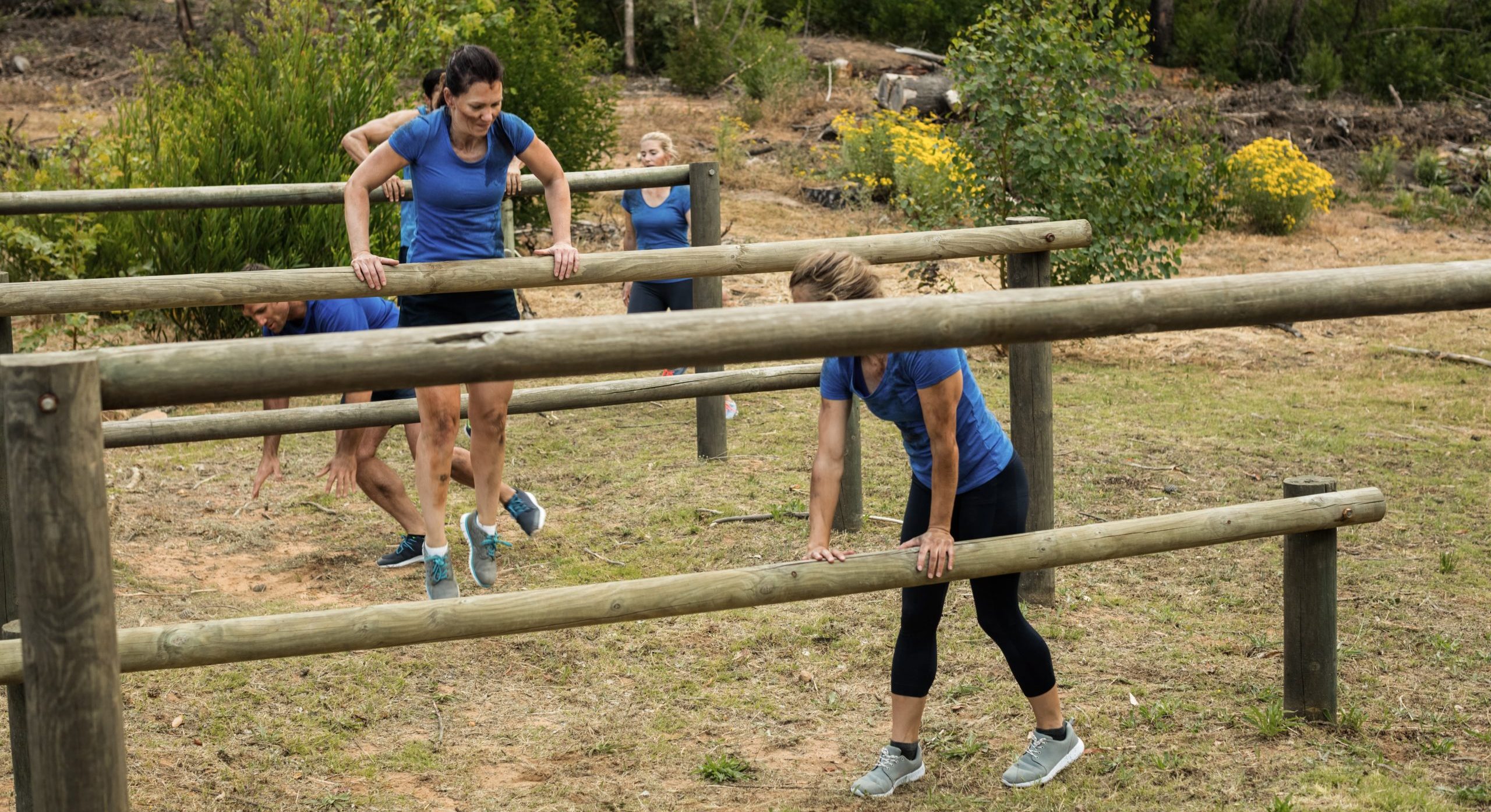 People jumping over the hurdles during obstacle course